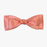 Ava satin bow in coral on a white background