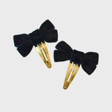 Black velvet bow snap clip. Chic accessory that’s perfect for securing your hair while adding a trendy twist to any outfit.