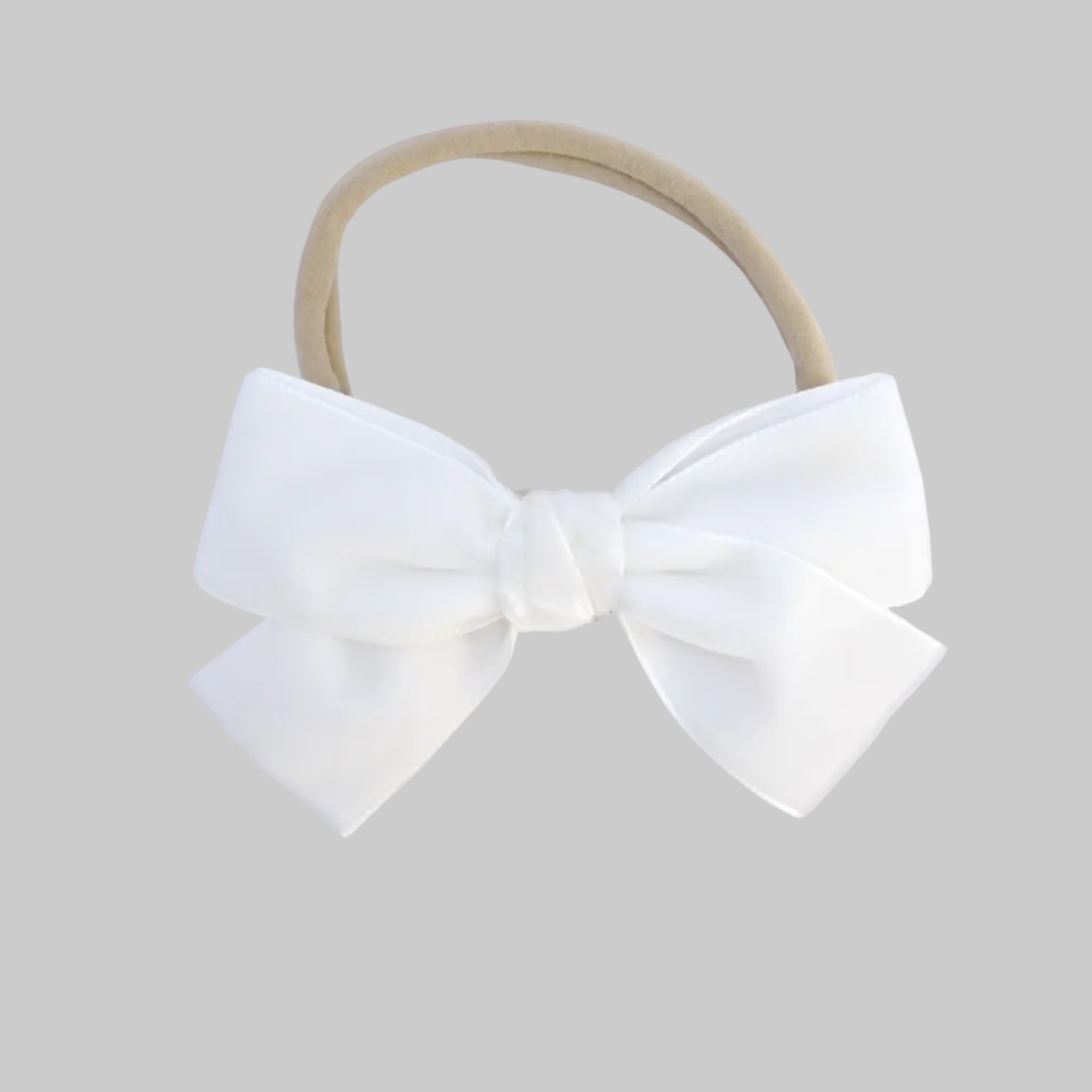 white Kayla velvet hair bow headband for baby girl.