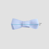 White bow tie with a measurement label on a light gray background