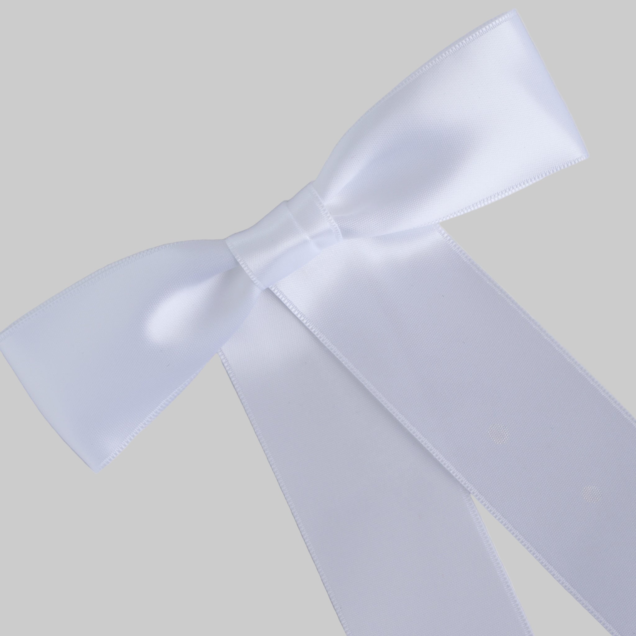 Close up of the Zoe petite satin hair bow  in white