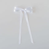 Olivia Picot Satin Bow accessory with picot edges, perfect for hairstyles of women and girls, available with a clip or barrette.