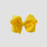 Yellow hair bow on a white background