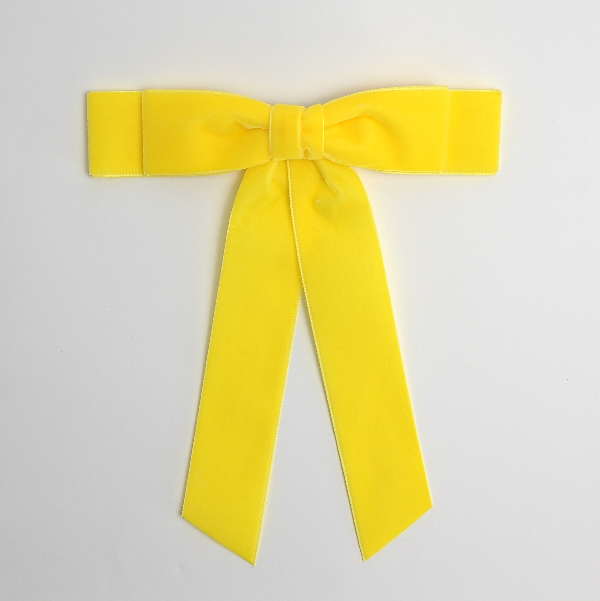 Yellow Grace velvet hair bow for women. Double bow with long tails on white background 