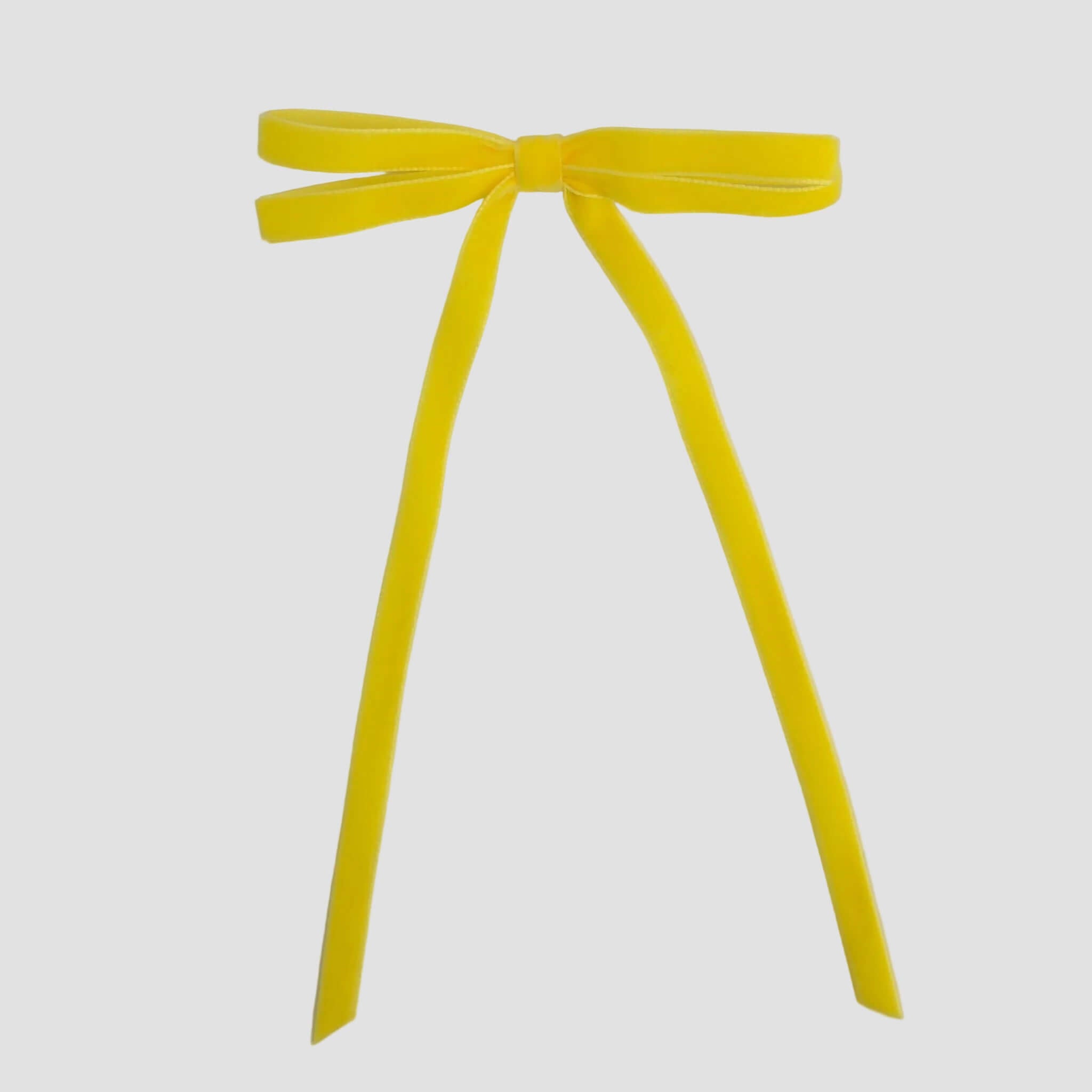 Yellow Olivia velvet hair bow for women with long tails on white background