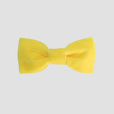 Yellow velvet bow tie on a white background
