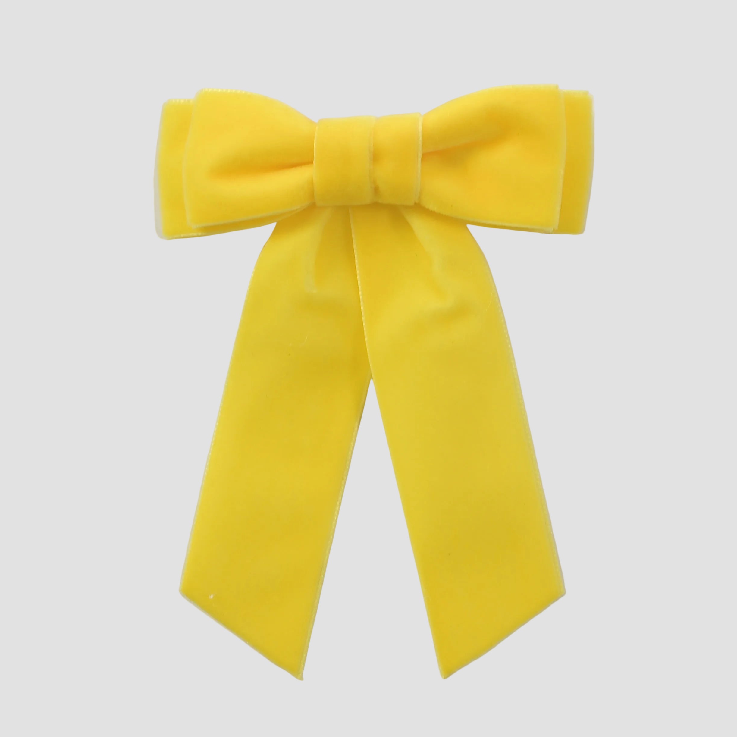 Yellow velvet Mia bow on a white background