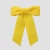 Yellow velvet Mia bow on a white background
