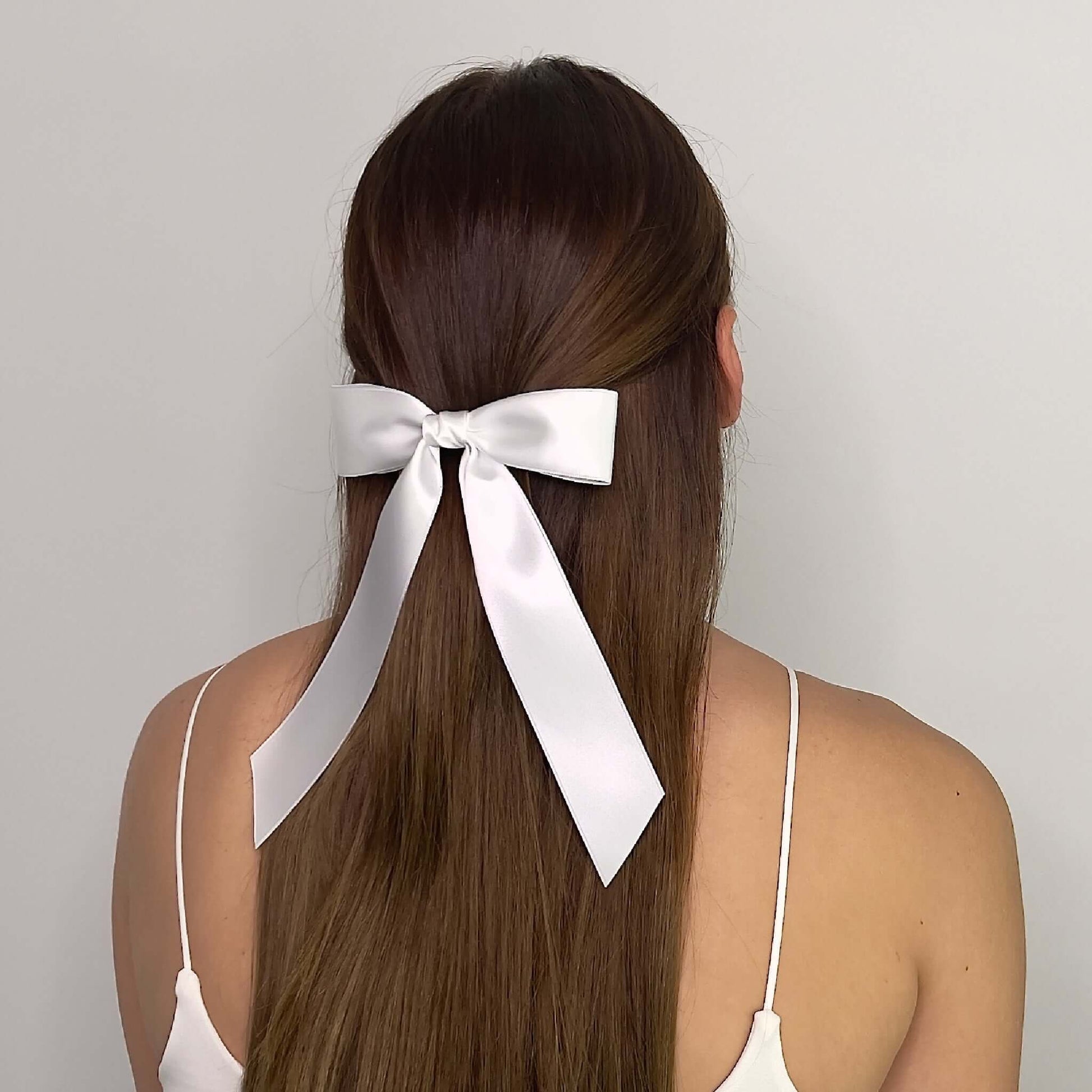 model wearing bow in white satin