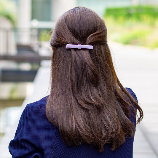 Model wearing lavender velvet bow barrette.